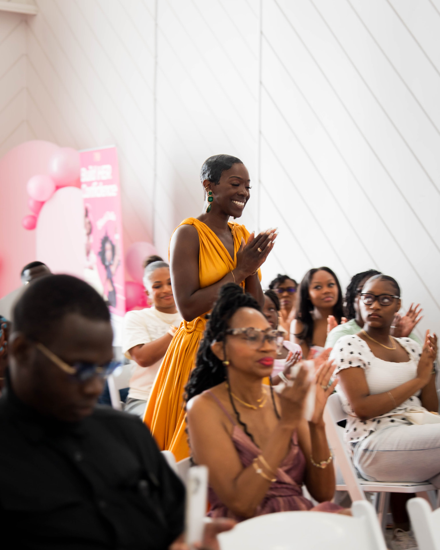 Community members applauding at a CROWNED event